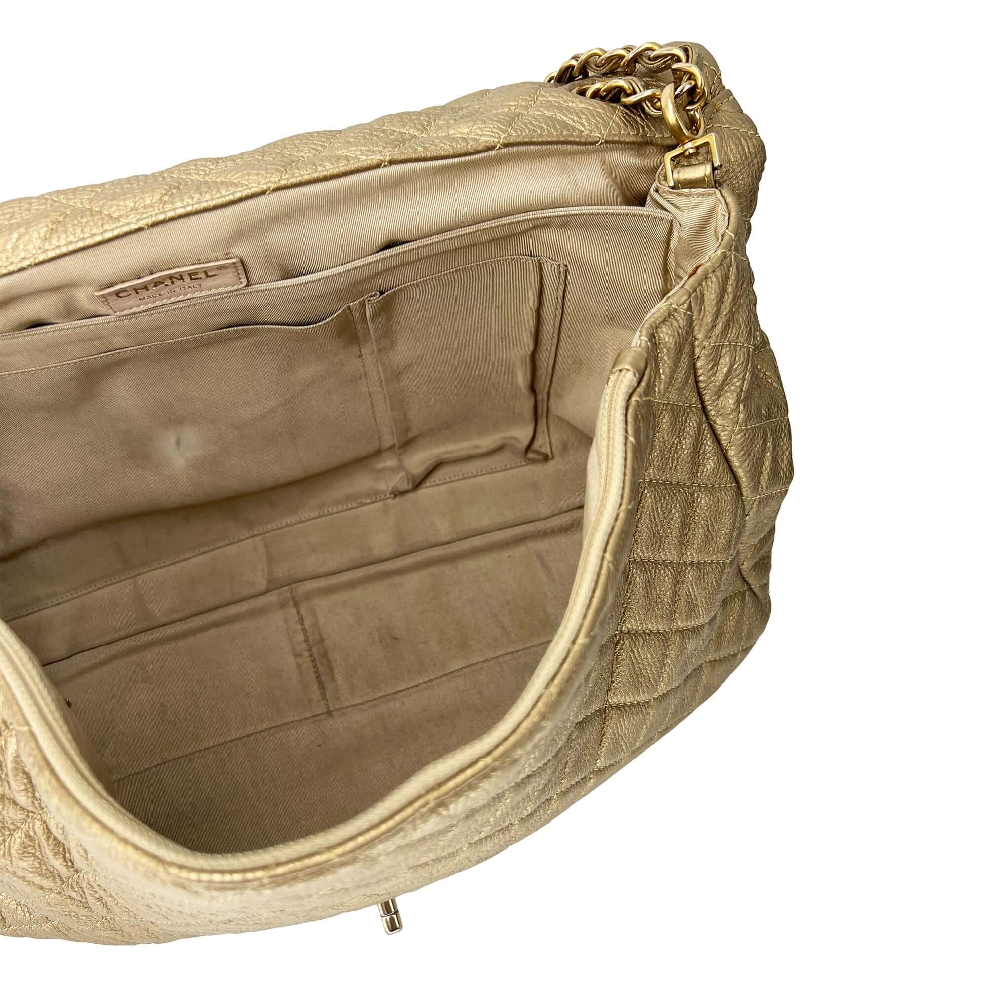 Chanel gold quilted leather travel bag